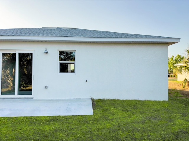 back of property featuring a patio and a yard