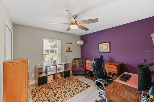 office area with light hardwood / wood-style floors and ceiling fan