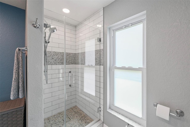 bathroom with a wealth of natural light and an enclosed shower