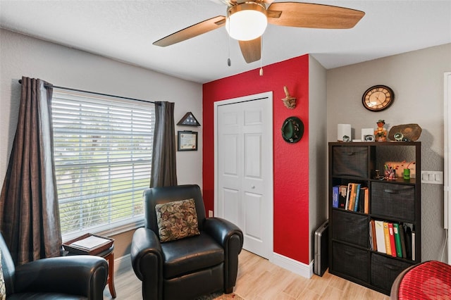 sitting room featuring ceiling fan and light hardwood / wood-style flooring