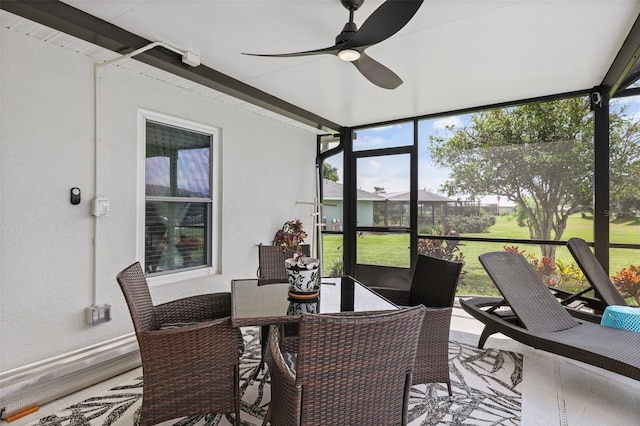 sunroom / solarium featuring ceiling fan and a wealth of natural light