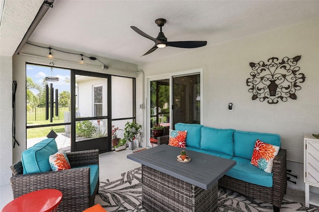 sunroom / solarium featuring ceiling fan