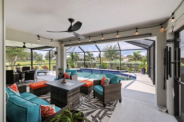 view of patio featuring glass enclosure, ceiling fan, and outdoor lounge area