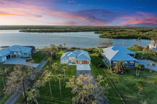 aerial view at dusk with a water view