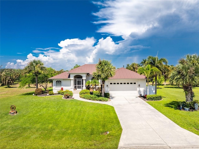 mediterranean / spanish-style house featuring a garage and a front lawn