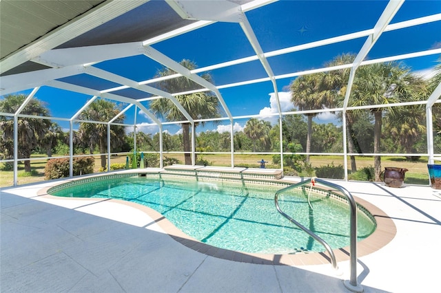 view of pool with a patio area and a lanai