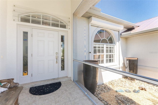 16407 San Edmundo Rd, Punta Gorda, FL 33955 - view of exterior entry with a metal roof and stucco siding