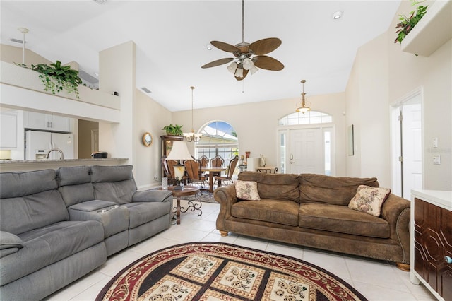 living room with light tile patterned floors, ceiling fan with notable chandelier, and high vaulted ceiling