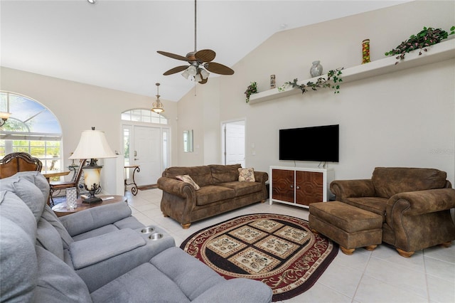 tiled living room with ceiling fan and high vaulted ceiling