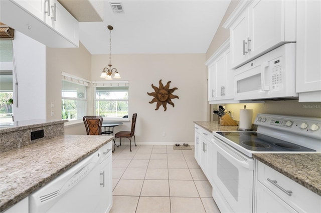 kitchen featuring white appliances, white cabinets, vaulted ceiling, light tile patterned floors, and decorative light fixtures