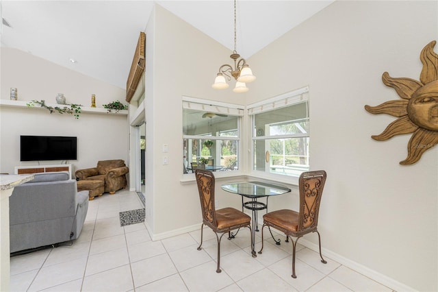 dining space featuring light tile patterned flooring, a chandelier, and high vaulted ceiling