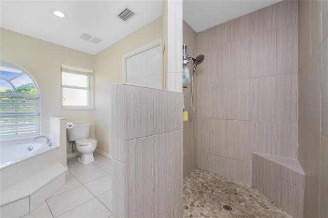 bathroom featuring tile patterned flooring, shower with separate bathtub, and toilet