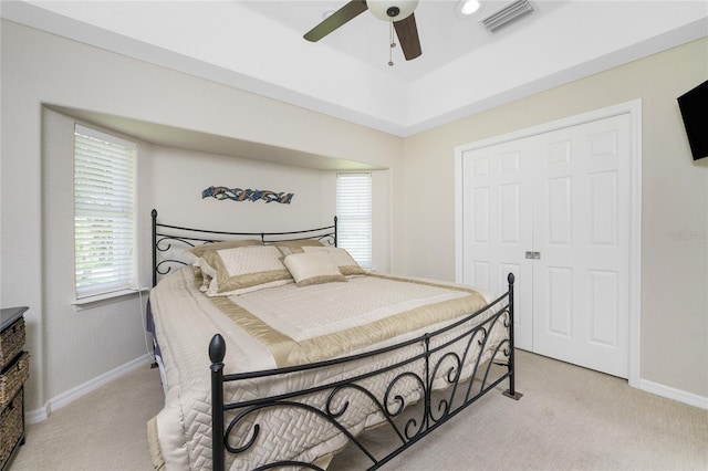 bedroom with light carpet, a closet, and ceiling fan