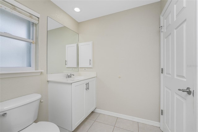 bathroom featuring tile patterned floors, vanity, and toilet