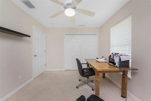 carpeted office featuring ceiling fan