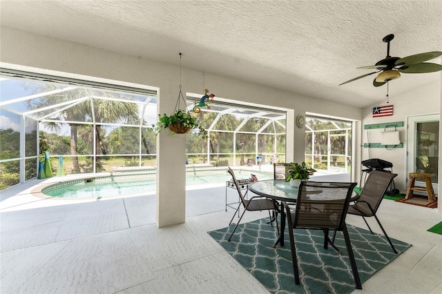 exterior space with vaulted ceiling, a pool, and ceiling fan