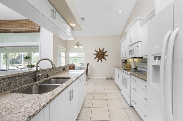 16407 San Edmundo Rd, Punta Gorda, FL 33955 - kitchen featuring white appliances, white cabinets, plenty of natural light, light stone counters, and recessed lighting