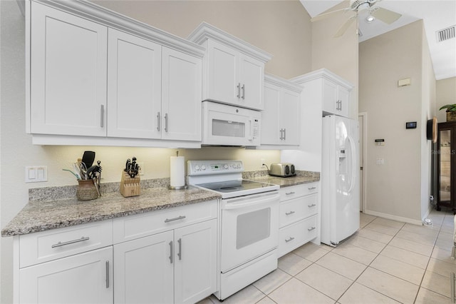 16407 San Edmundo Rd, Punta Gorda, FL 33955 - kitchen with white appliances, white cabinetry, a ceiling fan, light tile patterned floors, and light stone counters