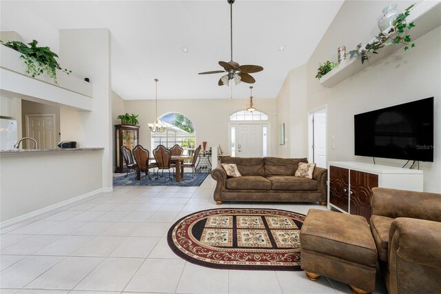 16407 San Edmundo Rd, Punta Gorda, FL 33955 - living area with ceiling fan, light tile patterned flooring, high vaulted ceiling, and a chandelier