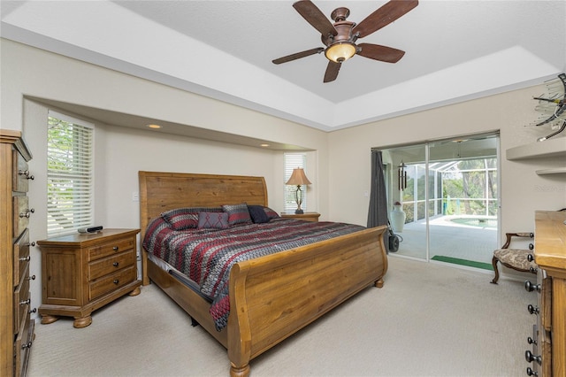 16407 San Edmundo Rd, Punta Gorda, FL 33955 - bedroom with light colored carpet, access to outside, multiple windows, and a tray ceiling