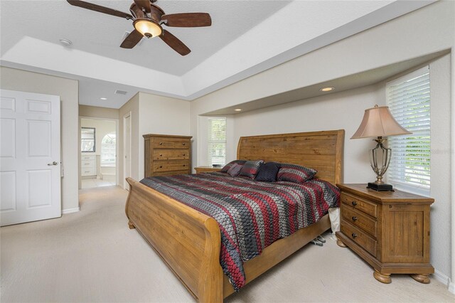 16407 San Edmundo Rd, Punta Gorda, FL 33955 - bedroom with light colored carpet, multiple windows, ensuite bathroom, a ceiling fan, and recessed lighting