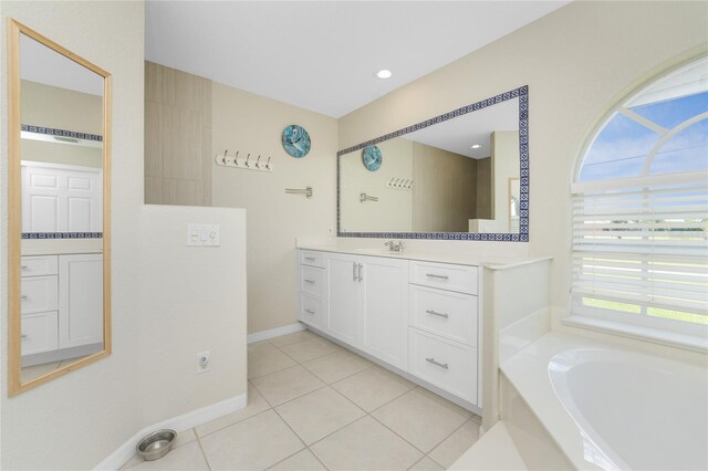 16407 San Edmundo Rd, Punta Gorda, FL 33955 - bathroom featuring vanity, a garden tub, and tile patterned floors