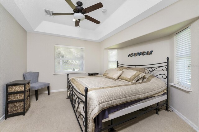 16407 San Edmundo Rd, Punta Gorda, FL 33955 - bedroom with a raised ceiling, light carpet, and a ceiling fan