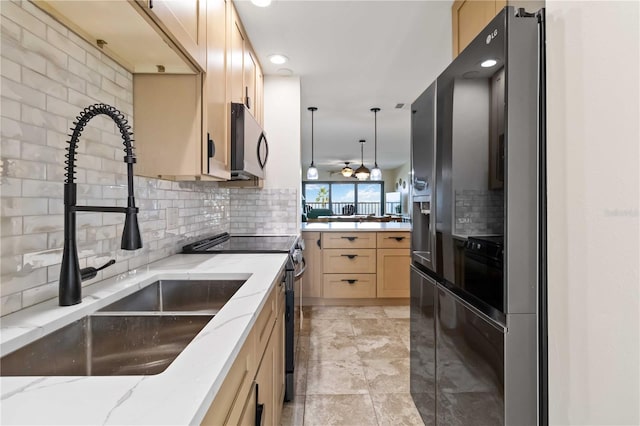 kitchen featuring light stone countertops, black refrigerator with ice dispenser, backsplash, hanging light fixtures, and stainless steel electric range