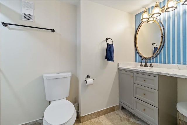 bathroom with toilet and vanity