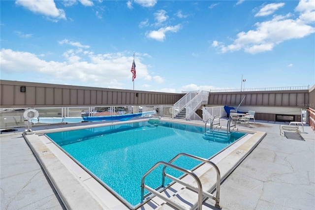 view of swimming pool with a patio