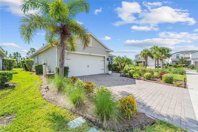 view of side of property with a garage and a lawn