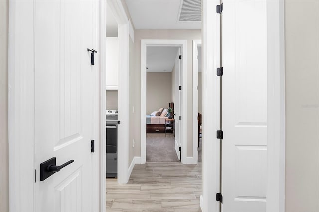 corridor featuring light hardwood / wood-style flooring