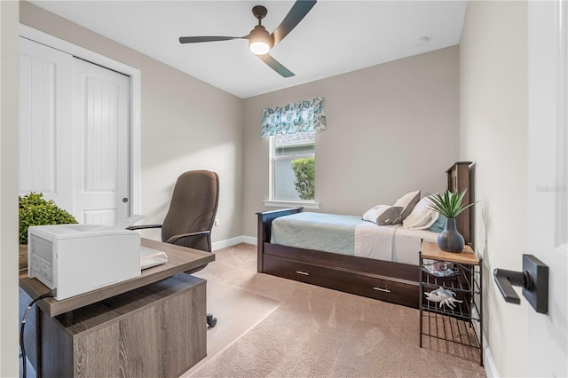 carpeted bedroom featuring a closet and ceiling fan