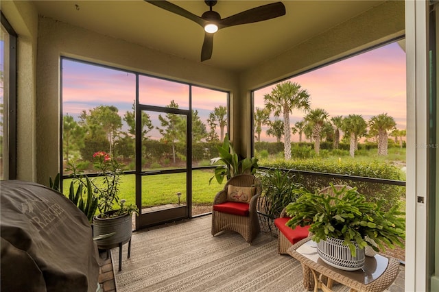 sunroom / solarium featuring ceiling fan