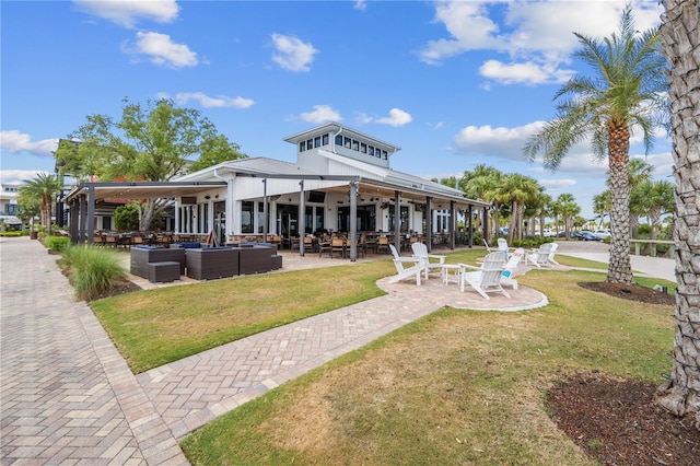 back of house with an outdoor hangout area, a yard, and a patio