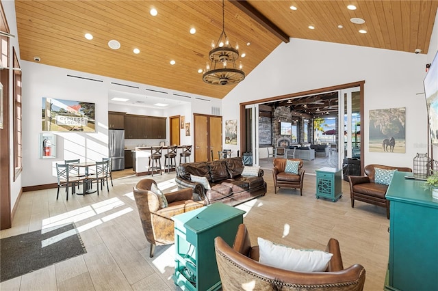 living room with plenty of natural light, high vaulted ceiling, wooden ceiling, an inviting chandelier, and light hardwood / wood-style floors