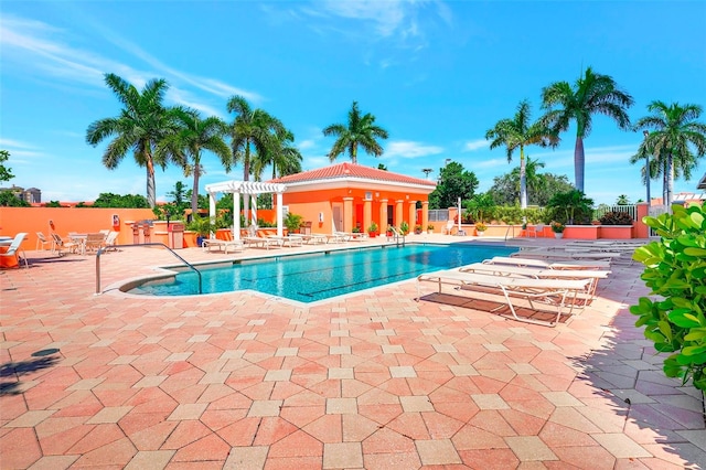 view of swimming pool with a pergola and a patio