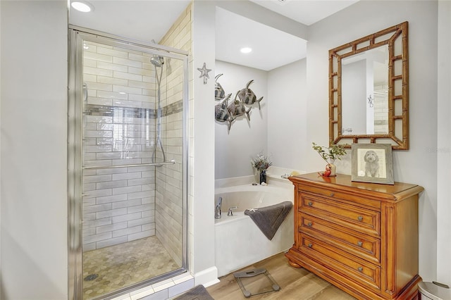 bathroom with wood-type flooring and plus walk in shower