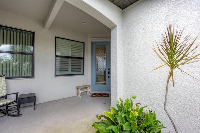 entrance to property with a patio