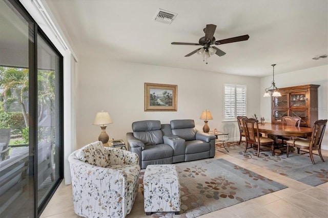 living room with ceiling fan and light tile patterned floors