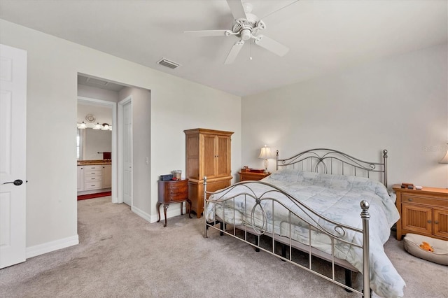 carpeted bedroom featuring ensuite bath and ceiling fan