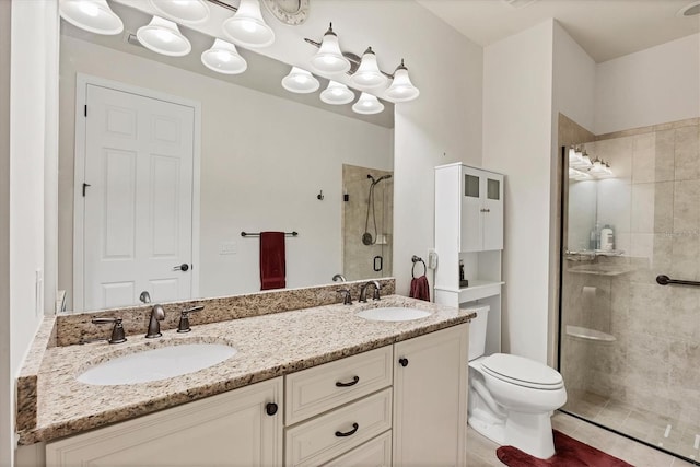 bathroom with a shower with door, toilet, and vanity