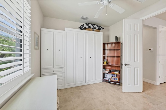 bedroom with ceiling fan and light tile patterned flooring