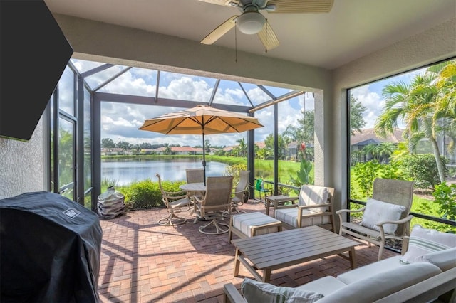 view of patio / terrace with glass enclosure, an outdoor living space, ceiling fan, and a grill