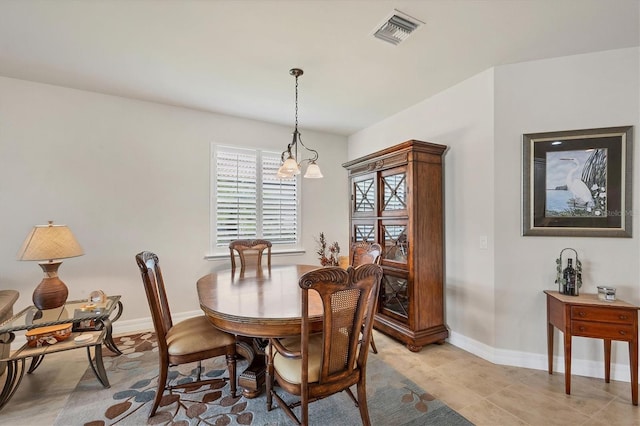 dining area featuring a notable chandelier and light tile patterned floors