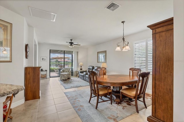 dining space featuring ceiling fan with notable chandelier and light tile patterned flooring