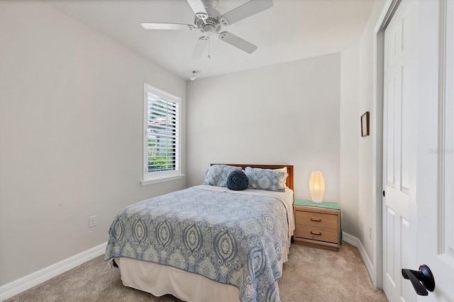 bedroom with ceiling fan, a closet, and light carpet