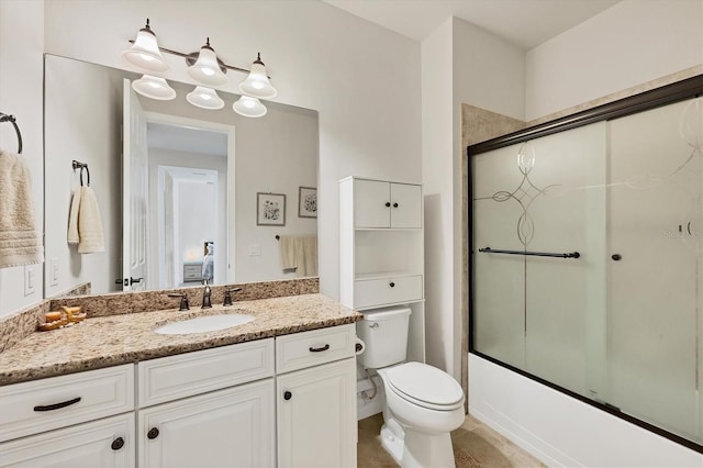 full bathroom featuring vanity, toilet, and combined bath / shower with glass door