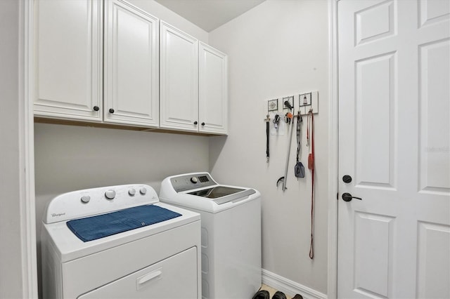 laundry area with washer and clothes dryer and cabinets