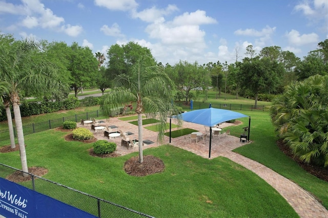 view of community featuring a lawn and a patio area